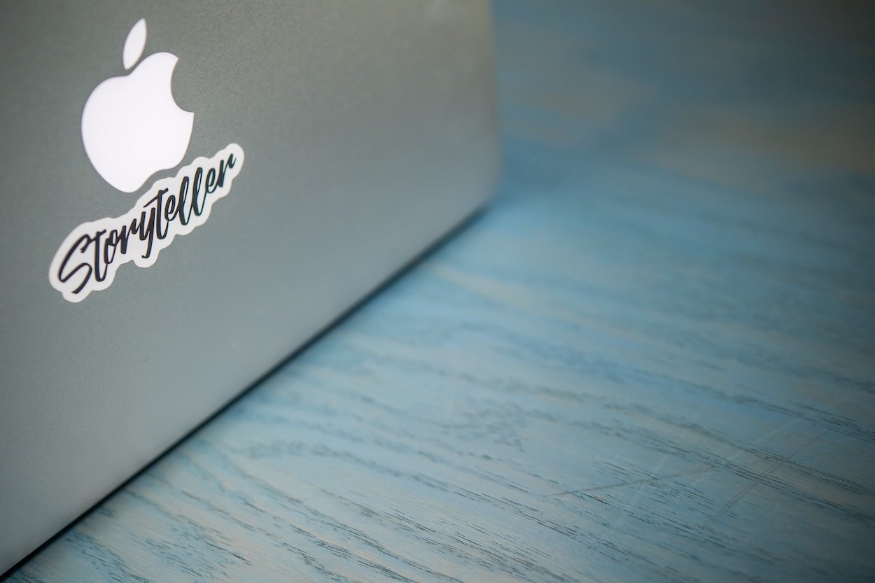 Computer with a sticker with the word "Storyteller"